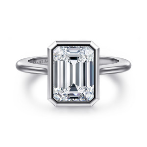 Gabriel & Co. ER16728E12W4JJJ 14 karat white gold Contemporary engagement ring, front view of an emerald cut center inside a clipped corner bezel on a smooth band