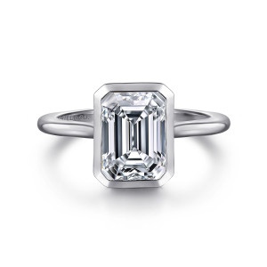 Gabriel & Co. ER16728E8W4JJJ 14 karat white gold Contemporary engagement ring, front view of an emerald cut center inside a smooth bezel with clipped corners