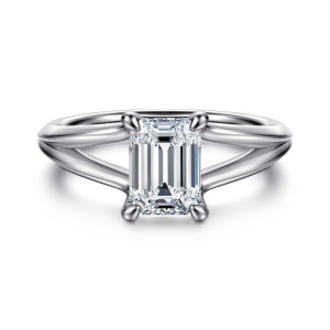 Gabriel & Co. ER16730E6W4JJJ 14 karat white gold Contemporary engagement ring, front view of the emerald cut center in pointed claw prongs above a shank that parts in two