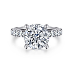 Gabriel & Co. ER16738R12W44JJ 14 karat white gold Contemporary engagement ring, front view of a round center on slender claw prongs between diamond set shoulders