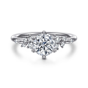 Gabriel & Co. ER16777R4W44JJ 14 karat white gold Starlight engagement ring, front view of a round center, ball tipped prongs and loose small diamond clusters on each shoulder