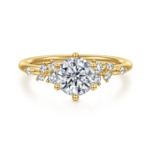 Gabriel & Co. ER16777R4Y44JJ 14 karat yellow gold Starlight engagement ring, front view of a round center with ball tipped prongs and small stones scattered on both shoulders