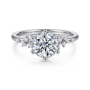 Gabriel & Co. ER16777R6W44JJ 14 karat white gold Starlight engagement ring, front view of a round center held by ball tipped prongs with tiny stones scattered on both shoulders