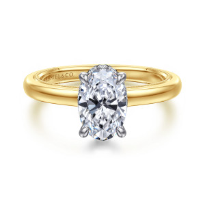 Gabriel & Co. ER16792O6M44JJ 14 karat white and yellow gold Classic engagement ring, front view of an oval center gripped by four paler prongs above a smooth band