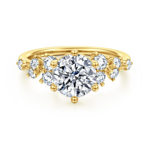 Gabriel & Co. ER16832R6Y44JJ 14 karat yellow gold Starlight engagement ring, front view of a round center in ball tipped prongs with scattered diamond clusters at each shoulder