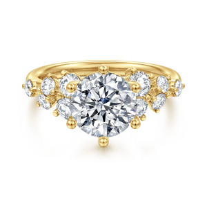 Gabriel & Co. ER16833R8Y44JJ 14 karat yellow gold Starlight engagement ring, front view of a round center on ball tipped prongs among clusters of round diamonds