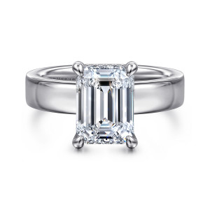 Gabriel & Co. ER16854E12W44JJ 14 karat white gold Classic engagement ring, front view of an emerald cut center in claw prongs on a broad polished band