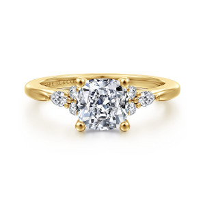 Gabriel & Co. ER16855C6Y44JJ 14 karat yellow gold Starlight engagement ring, front view of a cushion center with round and elongated stones clustered at each shoulder