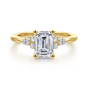 Gabriel & Co. ER16855E6Y44JJ 14 karat yellow gold Starlight engagement ring, front view of an emerald cut center with ball tipped prongs and small stone clusters at each shoulder