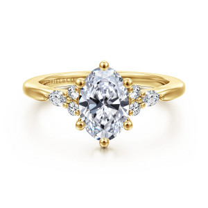Gabriel & Co. ER16855O6Y44JJ 14 karat yellow gold Starlight engagement ring, front view of an oval center with ball tipped prongs and stone clusters at both shoulders