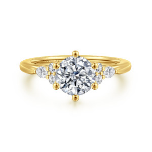 Gabriel & Co. ER16855R5Y44JJ 14 karat yellow gold Starlight engagement ring, front view of a round center in six ball tipped prongs, stone clusters on each shoulder