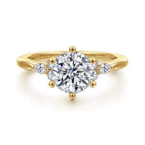 Gabriel & Co. ER16855R6Y44JJ 14 karat yellow gold Starlight engagement ring, front view of a round center held by six ball tipped prongs beside small shoulder clusters