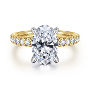 Gabriel & Co. ER16856O12M44JJ 14 karat white and yellow gold Contemporary engagement ring, front view of an oval center in a cooler toned head between rows of round diamonds