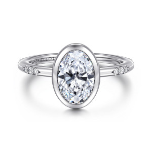 Gabriel & Co. ER16857O6W44JJ 14 karat white gold Contemporary engagement ring, front view of the smooth bezel rim around an oval center with a diamond cluster on each side