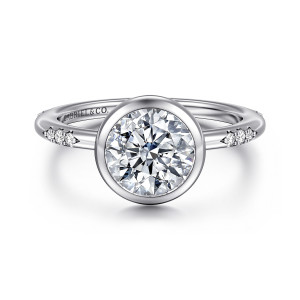 Gabriel & Co. ER16857R6W44JJ 14 karat white gold Contemporary engagement ring, front view of a round center in a smooth full bezel with stone clusters on the band
