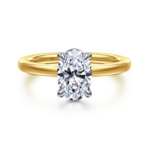 Gabriel & Co. ER16860O6M44JJ 14 karat white and yellow gold Classic engagement ring, front view of an oval center with claw prongs in a cooler tone against the warmer band