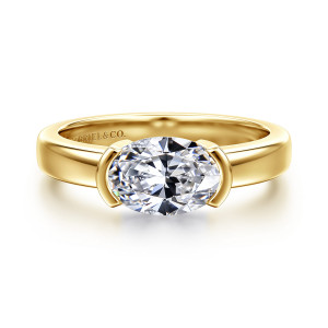 Gabriel & Co. ER16871O6Y4JJJ 14 karat yellow gold Contemporary engagement ring, front view of a sideways oval center held by a curved bar at each end
