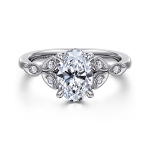 Gabriel & Co. ER16895O6W44JJ 14 karat white gold Victorian engagement ring, front view of an oval center flanked by beaded leaf frames each holding a small diamond