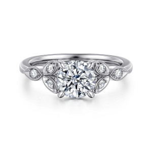 Gabriel & Co. ER16895R4W44JJ 14 karat white gold Victorian engagement ring, front view of the round center between beaded leaf panels each set with a small round diamond