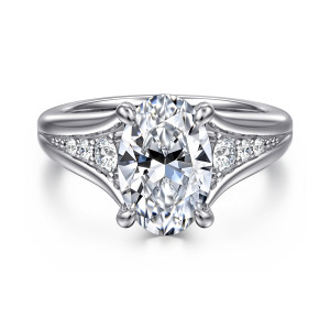 Gabriel & Co. ER16896O10W44JJ 14 karat white gold Contemporary engagement ring, front view of an oval center on four prongs above a split shank holding round diamonds
