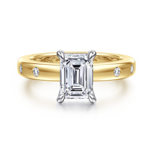 Gabriel & Co. ER16898E6M44JJ 14 karat white and yellow gold Contemporary engagement ring, front view of an emerald cut center with flush set round diamonds on each shoulder