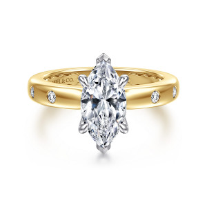 Gabriel & Co. ER16898M6M44JJ 14 karat white and yellow gold Contemporary engagement ring, front view of a marquise center held by pointed tip prongs, with bezel set stones on the band