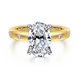 Gabriel & Co. ER16898O12M44JJ 14 karat white and yellow gold Contemporary engagement ring, front view of an oval center between teardrop tipped prongs with flush set round diamonds in the band