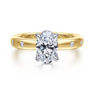 Gabriel & Co. ER16898O6M44JJ 14 karat white and yellow gold Contemporary engagement ring, front view of an oval center held by prongs with round stones set flush in the band shoulders