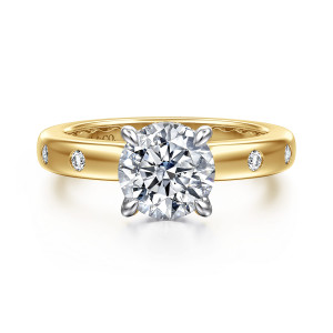 Gabriel & Co. ER16898R6M44JJ 14 karat white and yellow gold Contemporary engagement ring, front view of a round center held by four pointed prongs above a smooth broad band
