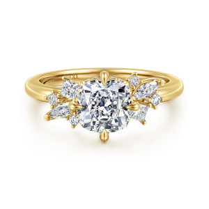 Gabriel & Co. ER16901C6Y44JJ 14 karat yellow gold Starlight engagement ring, front view of a cushion cut center with staggered small stones on each shoulder