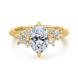 Gabriel & Co. ER16901O6Y44JJ 14 karat yellow gold Starlight engagement ring, front view of an oval center with a fanned cluster of mixed shape stones on each shoulder