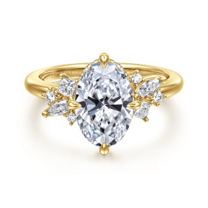 Gabriel & Co. ER16901O8Y44JJ 14 karat yellow gold Starlight engagement ring, front view of an oval center with teardrop tipped prongs and mixed stone clusters on both shoulders