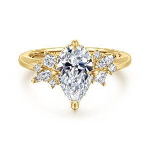 Gabriel & Co. ER16901P6Y44JJ 14 karat yellow gold Starlight engagement ring, front view of a pear shaped center with pointed prong tips and clusters on each shoulder