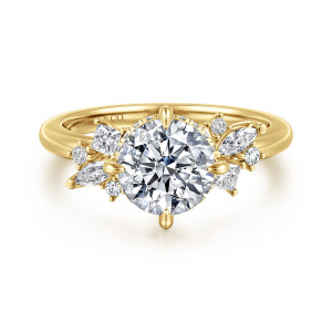 Gabriel & Co. ER16901R6Y44JJ 14 karat yellow gold Starlight engagement ring, front view of a round center held by four leaf shaped prongs between stone clusters