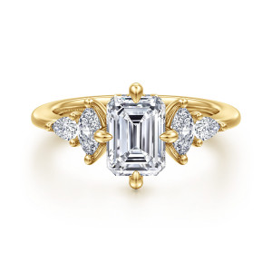 Gabriel & Co. ER16911E6Y44JJ 14 karat yellow gold Contemporary engagement ring, front view of an emerald cut center with prongs at each side and elongated shoulder stones