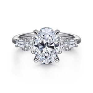 Gabriel & Co. ER16912O8W43JJ 14 karat white gold Classic engagement ring, front view of an oval center with tapered stones stepping down each shoulder