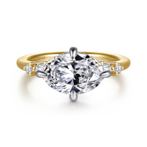 Gabriel & Co. ER16947O8M44JJ 14 karat white and yellow gold Contemporary engagement ring, front view of a sideways oval center held by four prongs with round diamonds on each shoulder