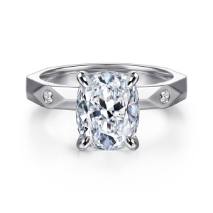 Gabriel & Co. ER16948G12W44JJ 14 karat white gold Contemporary engagement ring, front view of an elongated cushion center in four prongs above an angular faceted band