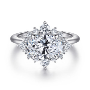Gabriel & Co. ER16962O8W44JJ 14 karat white gold Starlight engagement ring, front view of a sideways oval center ringed by a starburst of round stones and pointed ends