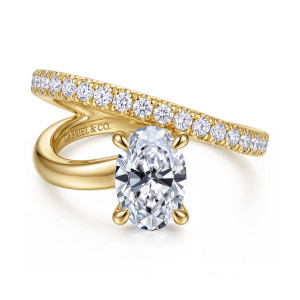 Gabriel & Co. ER16966O6Y44JJ 14 karat yellow gold Contemporary engagement ring, front view of the oval center with the row of round diamonds crossing above the plain arm