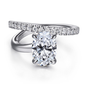 Gabriel & Co. ER16966O8W44JJ 14 karat white gold Contemporary engagement ring, front view of an oval center held by four prongs beneath a diamond set arm