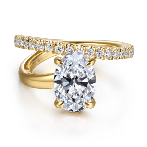 Gabriel & Co. ER16966O8Y44JJ 14 karat yellow gold Contemporary engagement ring, front view of an oval center with the diamond arm crossing above it