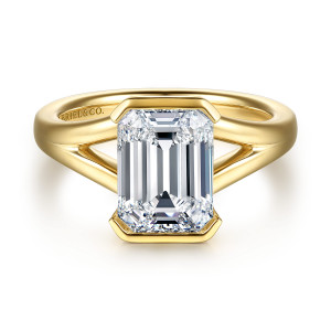Gabriel & Co. ER16969E12Y4JJJ 14 karat yellow gold Contemporary engagement ring, front view of an emerald cut center held by straight bezel rims at the top and bottom
