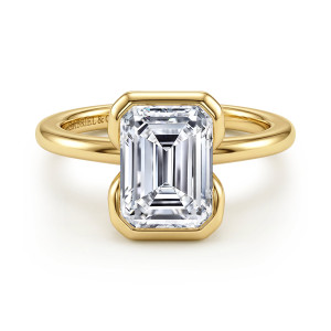 Gabriel & Co. ER16974E12Y4JJJ 14 karat yellow gold Contemporary engagement ring, front view of the emerald cut center in a bezel with clipped corners on a plain band