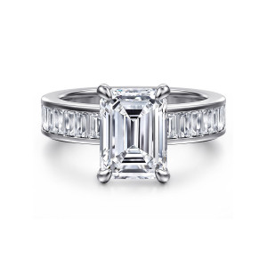 Gabriel & Co. ER16979E12W43JJ 14 karat white gold Contemporary engagement ring, front view of the emerald cut center on corner prongs above a channel of baguette diamonds