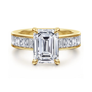 Gabriel & Co. ER16979E12Y43JJ 14 karat yellow gold Contemporary engagement ring, front view of an emerald cut center on claw prongs above a channel of baguette stones