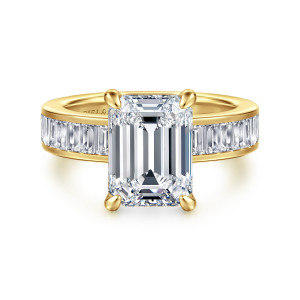Gabriel & Co. ER16979E16Y43JJ 14 karat yellow gold Contemporary engagement ring, front view of an emerald cut center on four corner prongs with baguette stones flanking the head