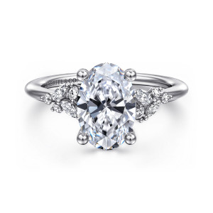 Gabriel & Co. ER16980O8W44JJ 14 karat white gold Floral Nouveau engagement ring, front view of an oval center on ball tipped prongs with a stone cluster on each shoulder