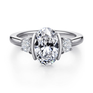 Gabriel & Co. ER16983O8W43JJ 14 karat white gold Contemporary engagement ring, front view of an oval center with metal walls along its long sides between larger side stones