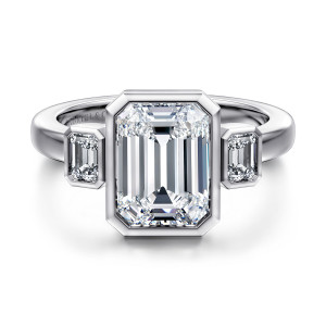 Gabriel & Co. ER16995E12W43JJ 14 karat white gold Contemporary engagement ring, front view of an emerald cut center in a clipped corner bezel between two step cut side stones